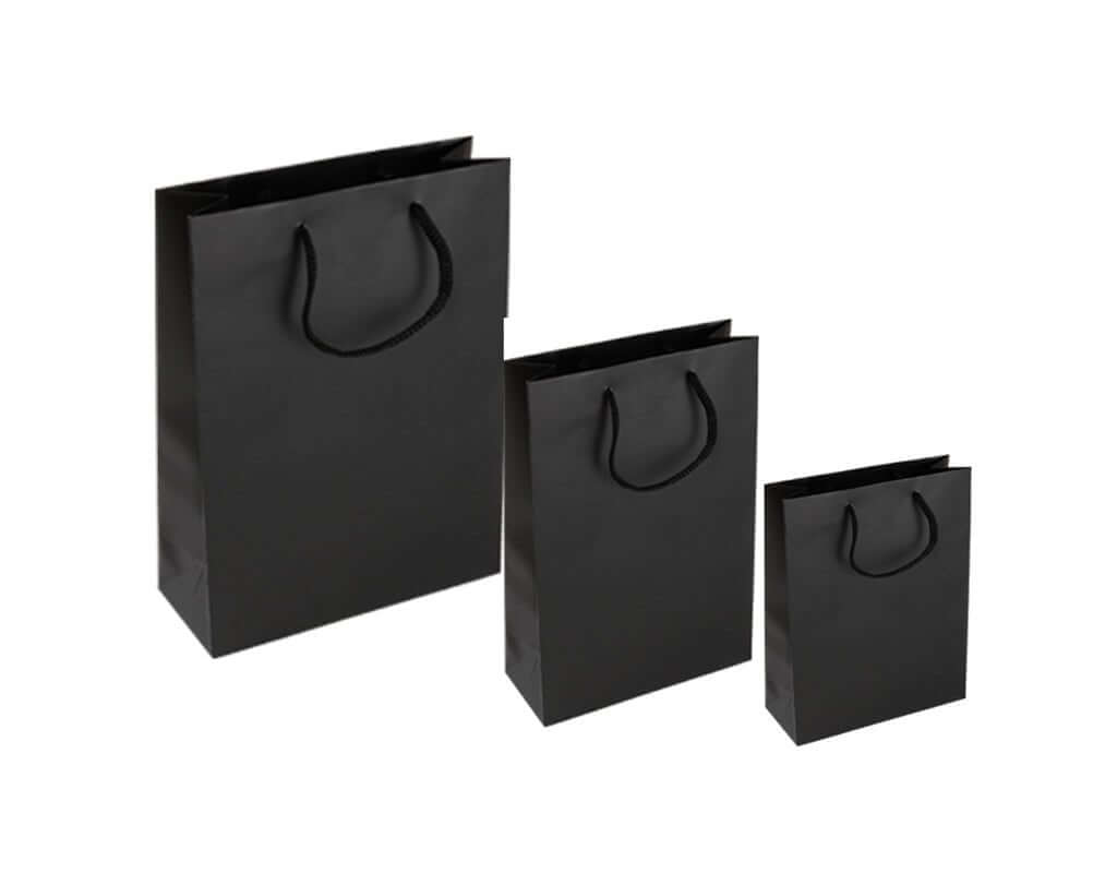 Large black paper gift bags in various sizes with sturdy rope handles.
