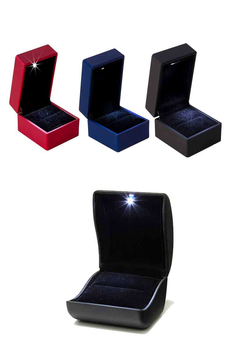 Set of four jewelry boxes in red, blue, and black on a white background